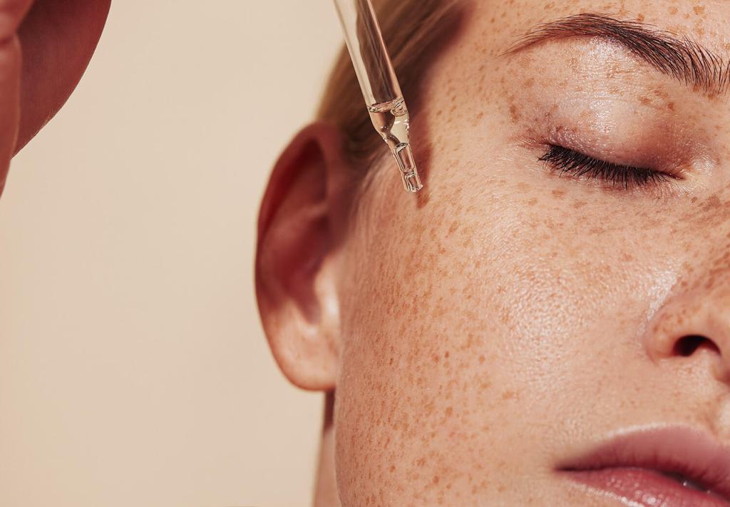 Close-up of hydrating serum being applied to smooth, healthy skin